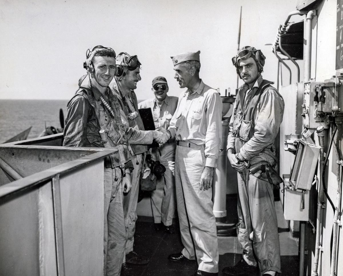 Group of military men shaking hands.